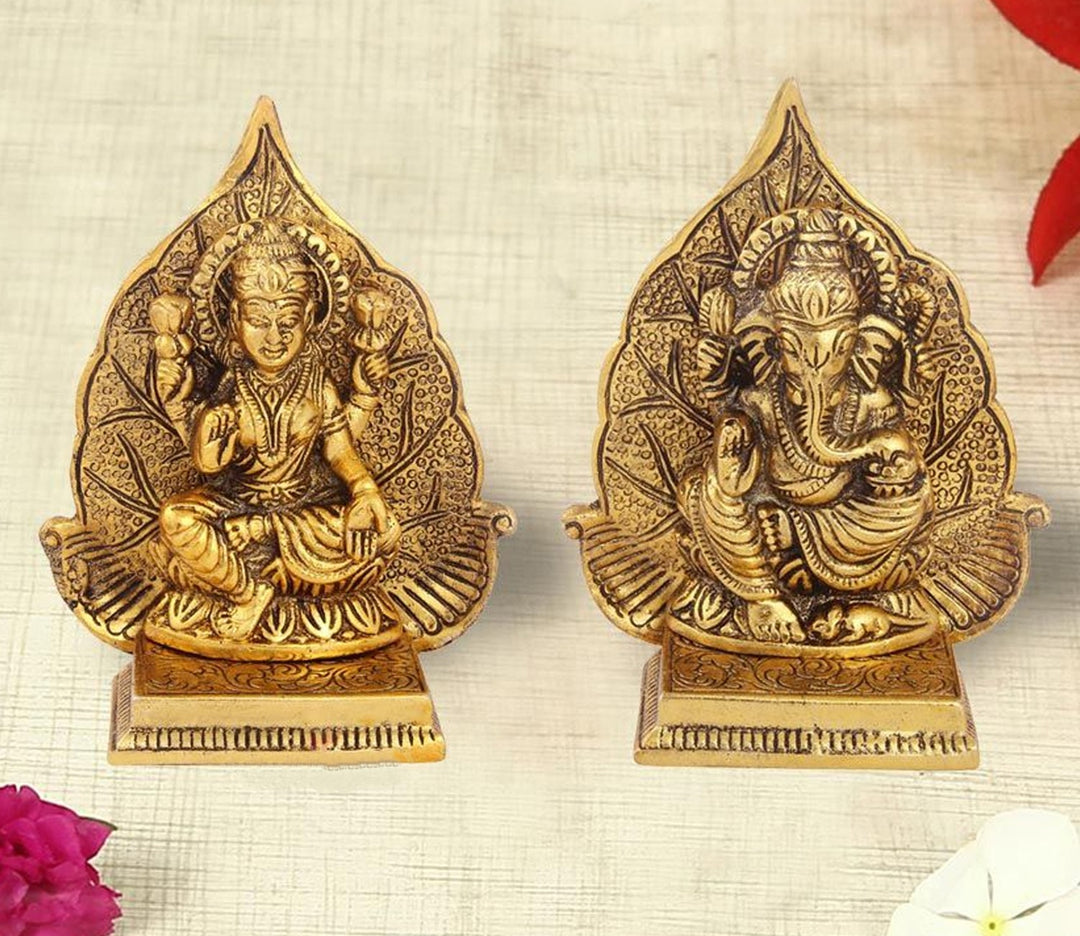 Captivating Antique Gold Plated Lakshmi Ganesh Pair with Leaf Background