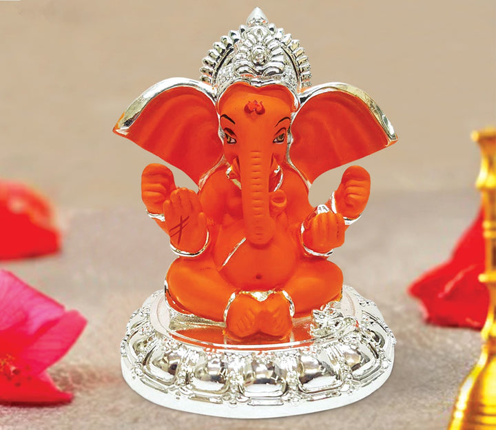 Captivating Sitting Ganesha Idol in Orange with Silver Base